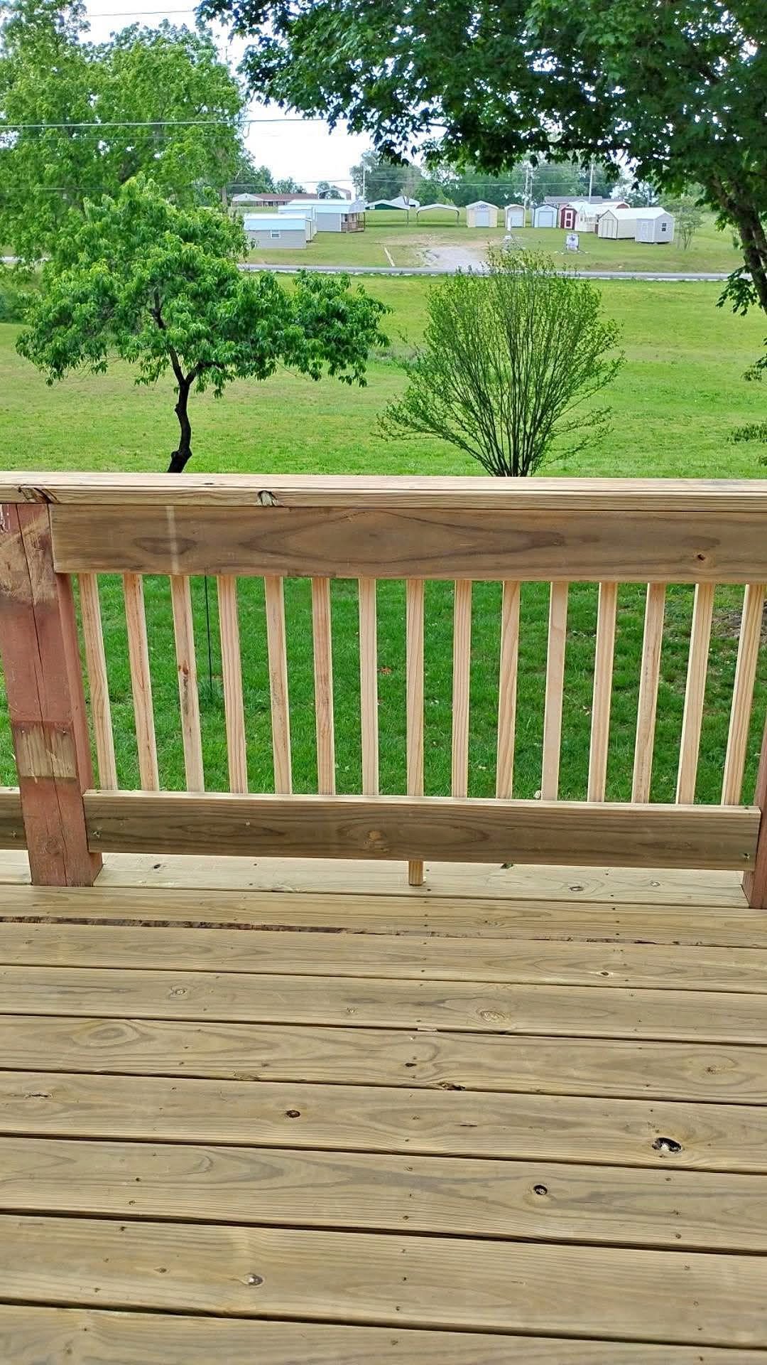 New wood deck railing and closely fitted deck boards